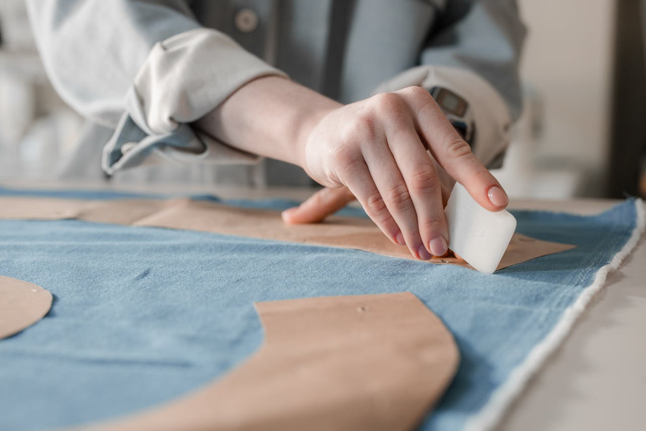 Detailed view of a tailor marking fabric with chalk. Perfect for sewing projects.